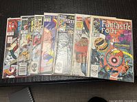 Row of nine bagged Marvel comic books on table