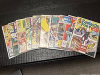 Angled group shot of entire lot displaying approximately fourteen bagged Marvel comic books