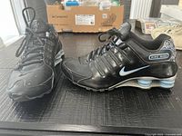 Full view of both Nike Shox NZ shoes showing overall design, color and condition