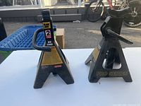 Front view of both jack stands showing capacity labels and overall wear
