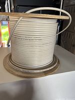 Side view of white RG6 coaxial cable on spool