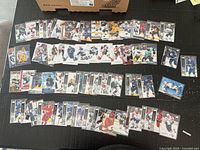 Wide shot showing three rows of sleeved Upper Deck hockey cards laid out on table