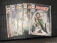 All five bagged Bloodshot comics fanned out showing covers