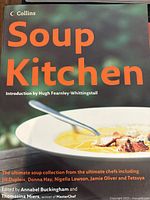 Cover photo of Soup Kitchen cookbook edited by Annabel Buckingham and Thomas Miers, featuring a bowl of soup with spoon and dark green background.