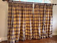 Full view of both silk drapes hanging on a curtain rod, showing overall size and horizontal stripe pattern in green, purple, and gold.