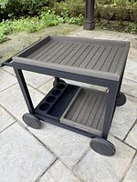 Assembled cart showing top slatted tray and bottom shelf with compartment tray.