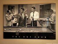 Front view of the black and white Rat Pack playing pool poster showing four men playing billiards, with "THE RAT PACK" text below the image.