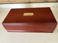 Closed wooden tea chest with brass TEAS plaque on top