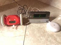 Clocky rolling alarm clock, Sonic Alert bedside alarm, round bed shaker pad with cords