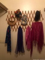 visors, cap, multicolor scarf, blue floral scarf, purple chiffon scarf, pink scarf, magenta fringed shawl on rack