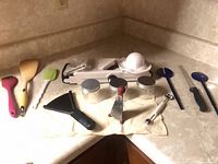 Full set of kitchen utensils and gadgets laid out on counter