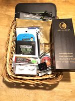 Overall lot in wicker basket showing brush box, lashes, masks, compact, pouch