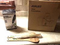 Group shot showing boxed hand blender, boxed juicer and bamboo utensils