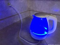 Kettle plugged in and illuminated blue on countertop
