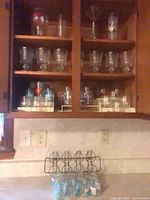 Overall cabinet view showing quantity and variety of glasses and rack