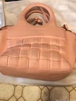 Front view showing peach quilted faux leather and handles