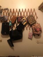 Overview of ten assorted bags hanging on wall lattice