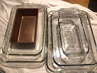Full view of nested glass dishes and metal loaf pan
