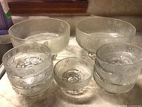 Group view of two large and seven small pressed-glass footed bowls