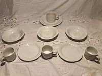 Overview showing all white ceramic pieces on tablecloth