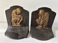 Front view of pair of cast iron bookends labeled 'Science' and 'Study' with seated children figures.