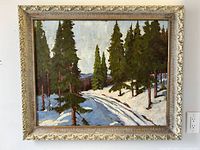 Full front view of framed oil painting showing snow and pine landscape