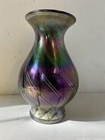 Full front view of the iridescent art glass vase showing colors and swirl pattern