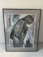 Front view of framed Emily Carr Great Eagle Totem print showing full artwork with reflection of light on glass.
