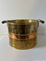 Front view of copper planter tub showing two wood handles and polished copper body with light oxidization.