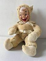 Front view of the elf goblin figure seated with visible facial details and plush fabric body.