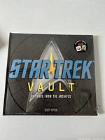 Front cover of the sealed Star Trek Vault book showing title and design.