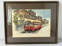 Full view of framed print showing red and cream Toronto streetcar #501 Humber in front of brick storefronts.