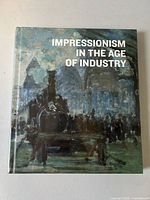 Front cover view of the sealed hardcover art book showing title and industrial-themed impressionist painting.