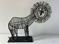 Front view of the abstract figural lion wired metal sculpture showing the full body and flat base.