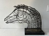 Front side view of the wired metal horse head sculpture showing overall shape and structure on white background.