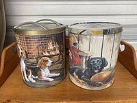 Set of two dog food tins showing beagle dogs and black labrador illustrations on the tins, metal with lids