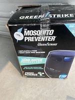 Box front showing the Green Strike Mosquito Preventer branding, features like Zero-Hatch Technology and mosquito population reduction claims.