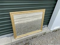 Full view of rectangular wall mirror with gold wood frame, showing proportions and overall appearance.
