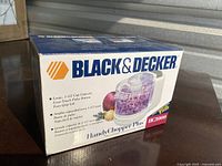Box front showing Black & Decker Handy Chopper Plus HC3000 brand, model, and product image with capacity and features.