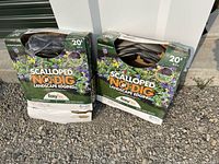 Two opened boxes of EasyFlex Scalloped No-Dig Landscape Edging, each 20 ft in length, showing the black layered edging material inside.