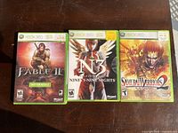 Front cover of the three Xbox 360 game cases side by side: Fable II, Ninety-Nine Nights, Samurai Warriors 2.
