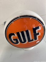 Front view of globe showing full orange field and GULF logo