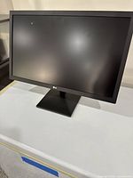 Front view of LG 22MN430H-B monitor showing screen and stand on table