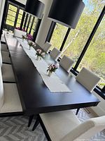 Front view of assembled table in room with tabletop and chairs in background