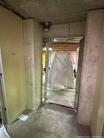 Mirror leaning against concrete wall in basement setting