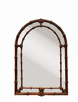 Full view of arched mirror with gold composite frame featuring faux bamboo and fleur-de-lis motifs