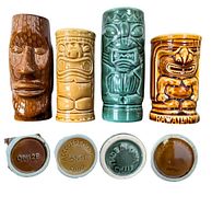 Four vintage ceramic tiki mugs front view with markings on bottom