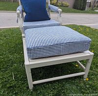 Close-up of ottoman frame and gingham cushion