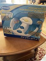 Boxed Dr. Scholl's pedicure foot spa unit shown from front, highlighting product image, branding, and features.