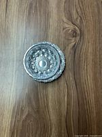 Top-down view of the stainless steel candy dish showing the central detailed pattern and decorative edging.